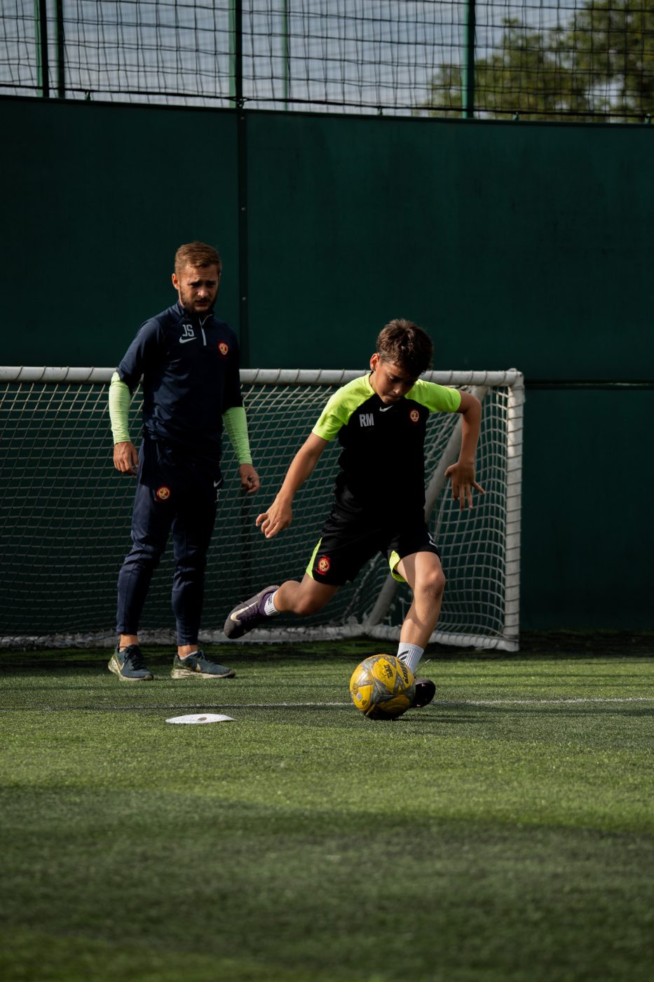 A Conquest coach working one-to-one with a player